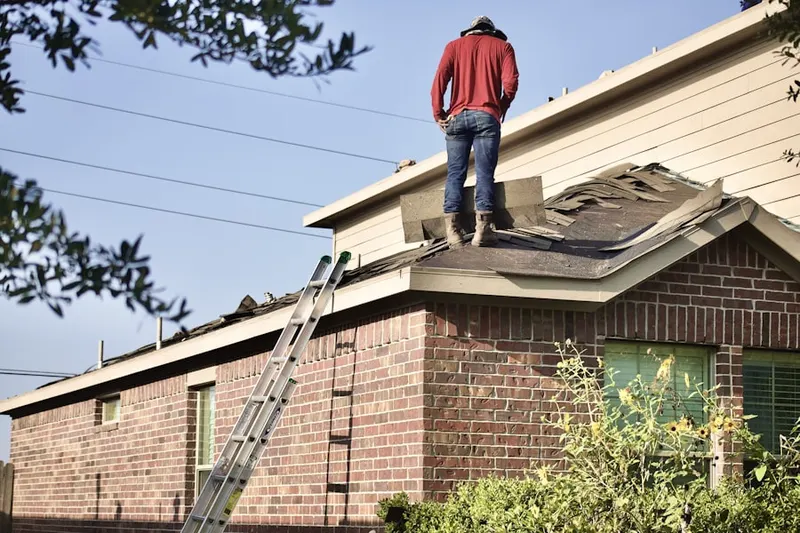 Professional roofer working on a residential roof in Marble Ridge Station